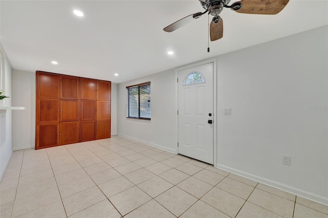 tiled foyer with ceiling fan