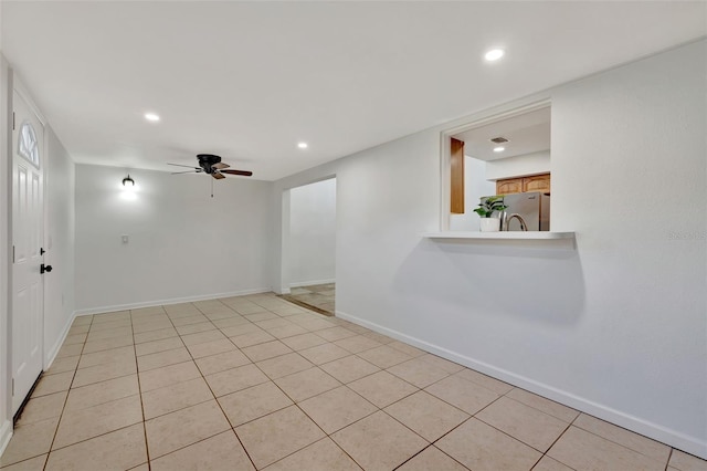 unfurnished room featuring ceiling fan and light tile patterned floors