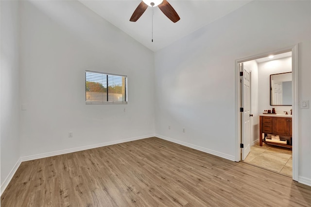 spare room featuring ceiling fan, sink, high vaulted ceiling, and light hardwood / wood-style floors