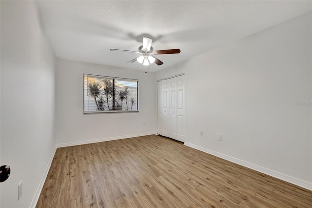 unfurnished room featuring light wood-type flooring and ceiling fan