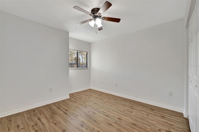 spare room featuring ceiling fan and light wood-type flooring