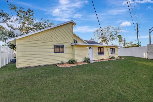 back of property featuring a yard