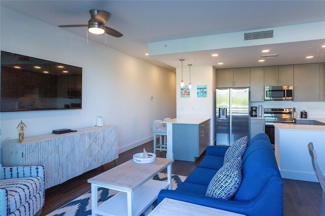 living room with dark hardwood / wood-style flooring and ceiling fan