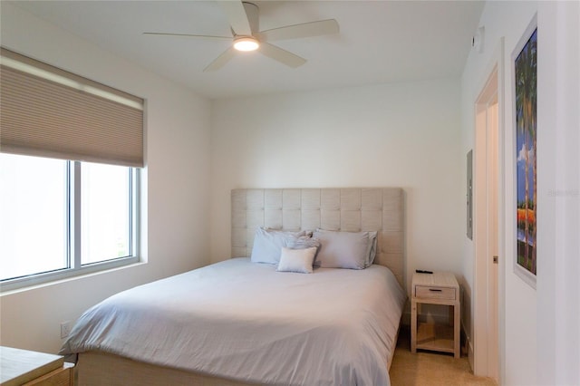 bedroom featuring light carpet and ceiling fan