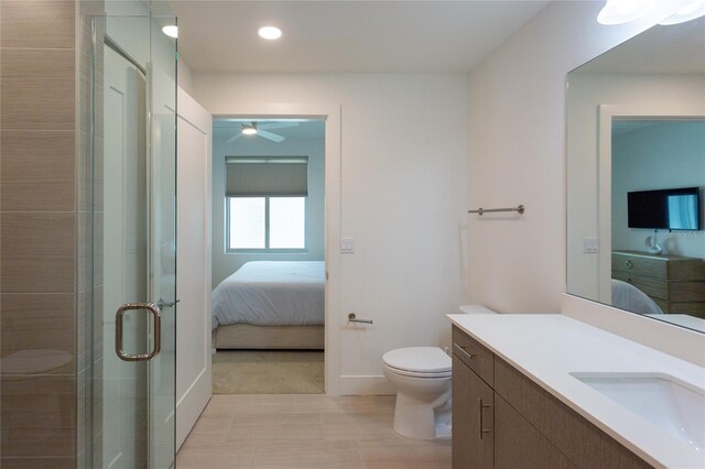 bathroom with ceiling fan, toilet, walk in shower, and vanity