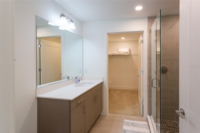 bathroom featuring vanity and an enclosed shower