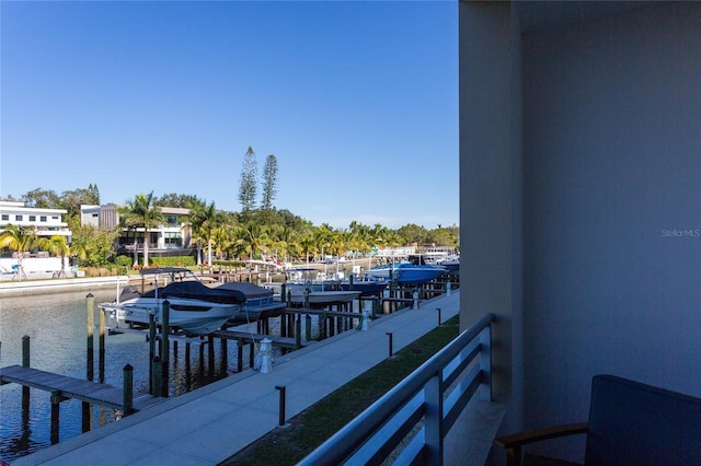 balcony with a boat dock and a water view