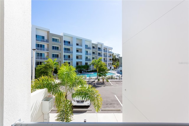 view of building exterior featuring a community pool