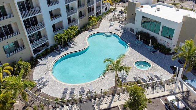 view of pool with a patio and a hot tub