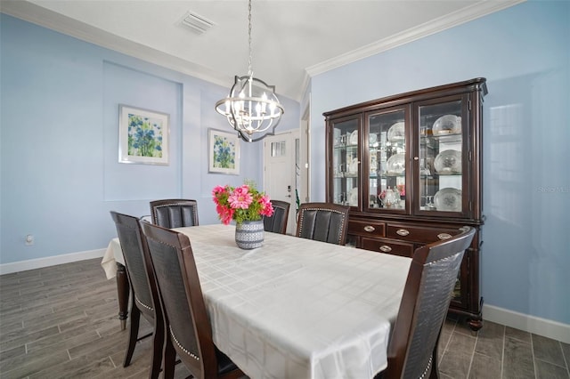 dining area featuring crown molding and a chandelier