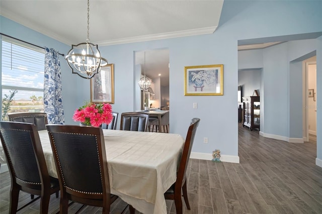 dining area featuring ornamental molding, dark hardwood / wood-style floors, and a notable chandelier