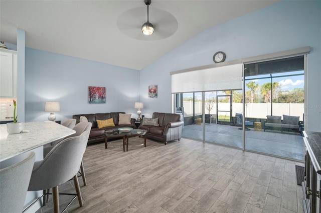 living room with high vaulted ceiling, light hardwood / wood-style floors, and ceiling fan