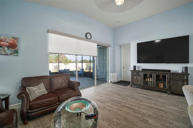 living room with hardwood / wood-style flooring and ceiling fan