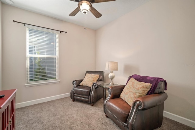 living area featuring light carpet and ceiling fan