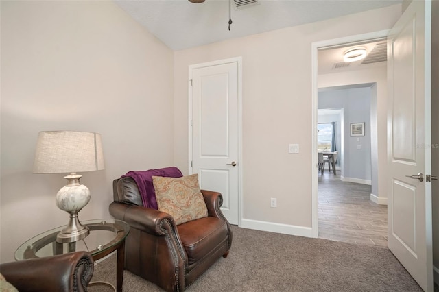 sitting room featuring light colored carpet and ceiling fan