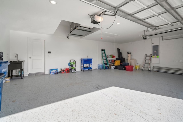 garage with sink, a garage door opener, and electric panel