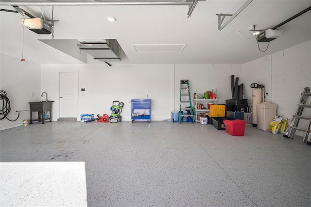 garage featuring a garage door opener and sink