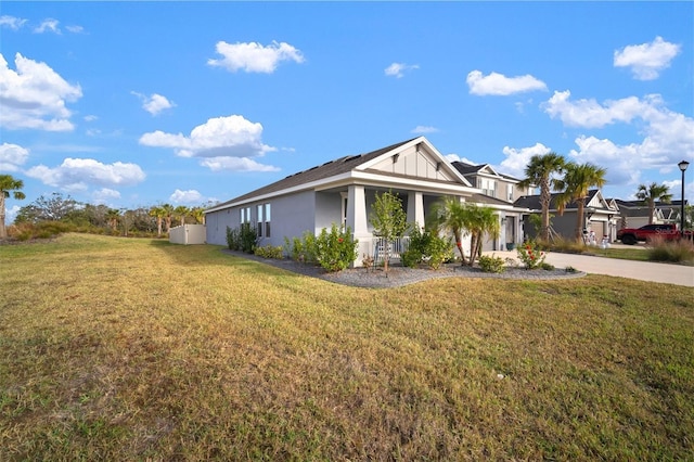 view of side of home with a lawn