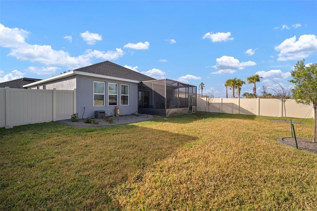 rear view of house featuring a yard and a lanai