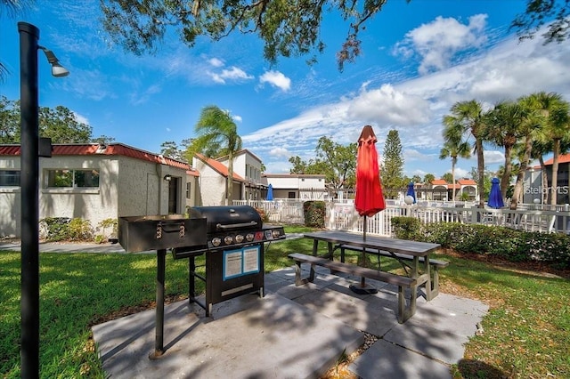 view of community with a patio area, a residential view, fence, and a lawn