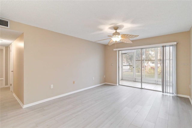 unfurnished room with ceiling fan, a textured ceiling, visible vents, baseboards, and light wood-type flooring