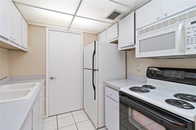 kitchen with white appliances, a sink, visible vents, white cabinetry, and light countertops