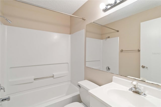 bathroom with a textured ceiling, toilet, bathing tub / shower combination, and vanity