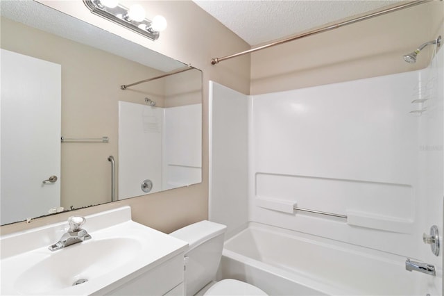 bathroom with  shower combination, a textured ceiling, toilet, and vanity