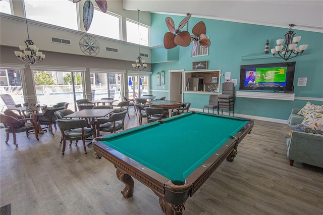 rec room featuring visible vents, a notable chandelier, and wood finished floors