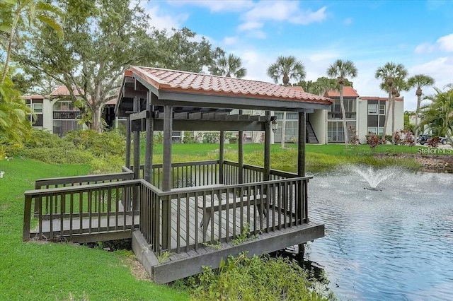 view of dock featuring a water view and a lawn