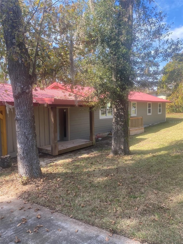 view of side of home with a yard