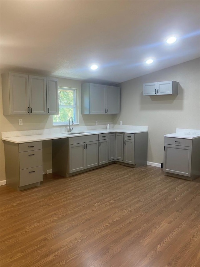 kitchen featuring dark hardwood / wood-style floors, gray cabinets, and sink