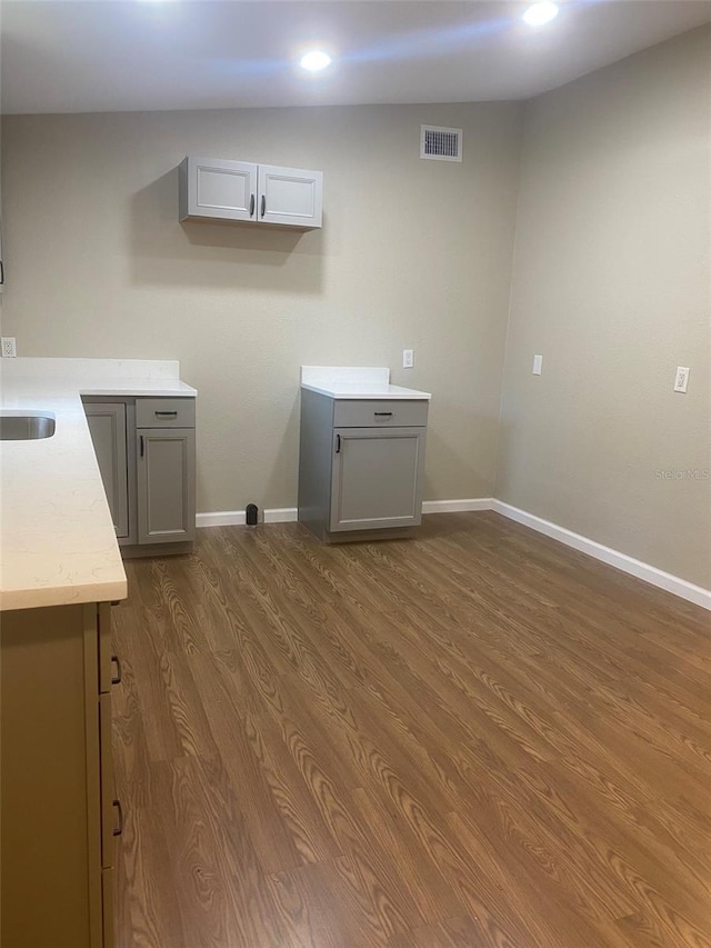 laundry room with dark wood-type flooring and sink