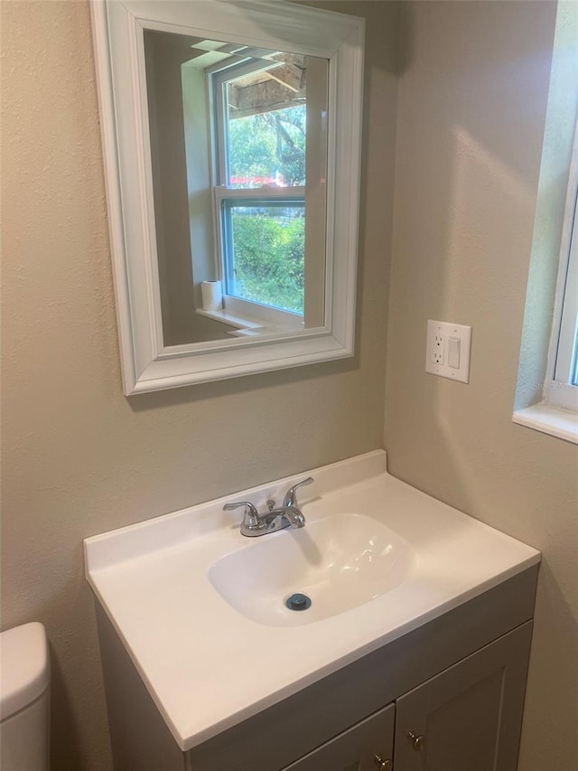 bathroom featuring vanity and toilet