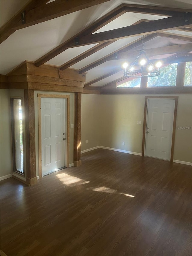 foyer entrance featuring a chandelier, lofted ceiling with beams, and dark wood-type flooring