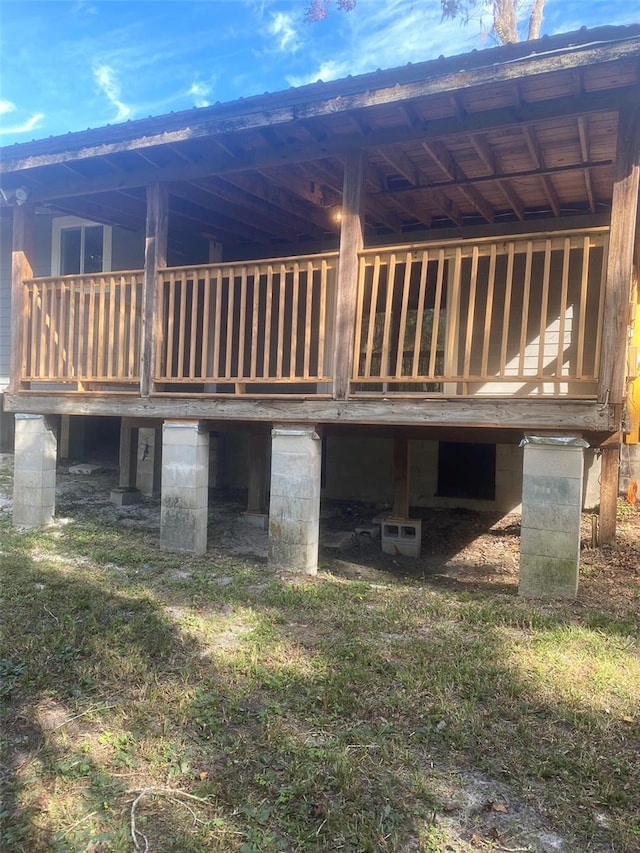 rear view of house featuring a wooden deck