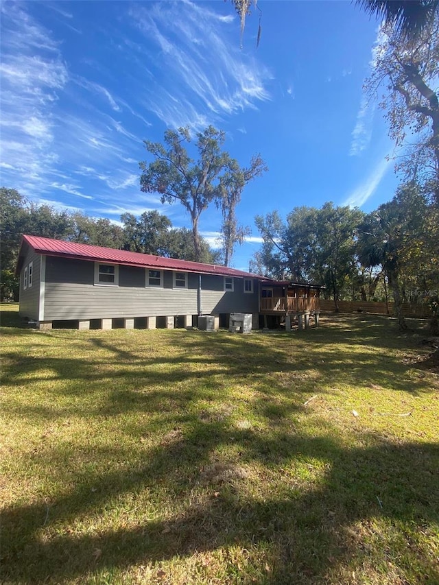 rear view of house featuring a yard