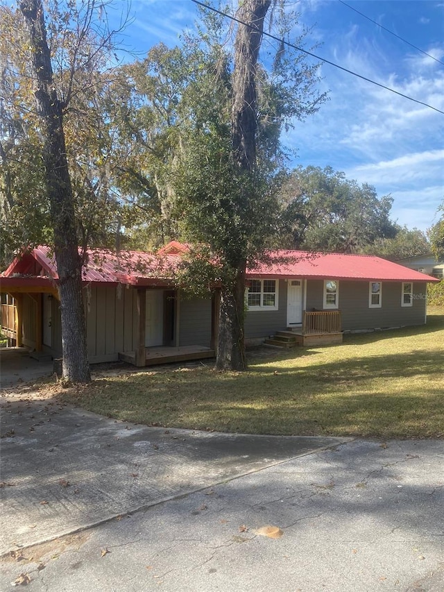 single story home with a carport and a front lawn