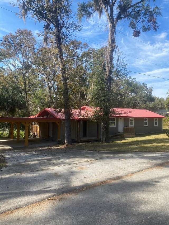 single story home featuring a carport