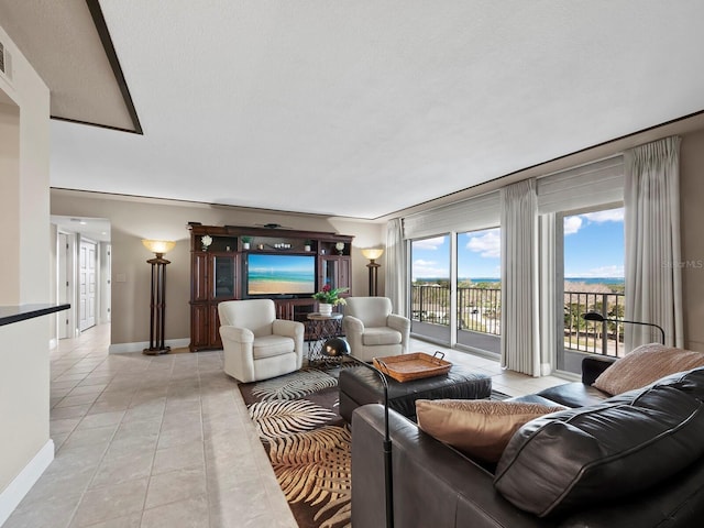 tiled living room featuring a textured ceiling