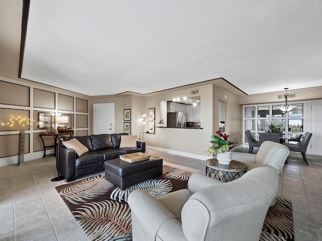 living room featuring tile patterned flooring and a textured ceiling