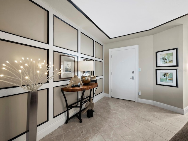 tiled foyer entrance featuring a chandelier