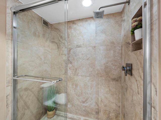 bathroom with a shower with shower door