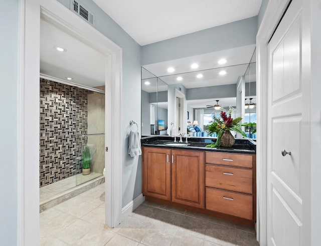 bathroom featuring ceiling fan, tile patterned floors, an enclosed shower, toilet, and vanity