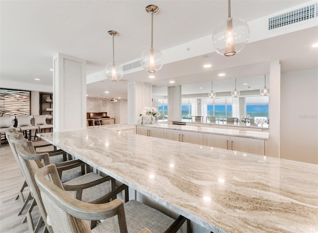 kitchen featuring white cabinets, kitchen peninsula, and hanging light fixtures