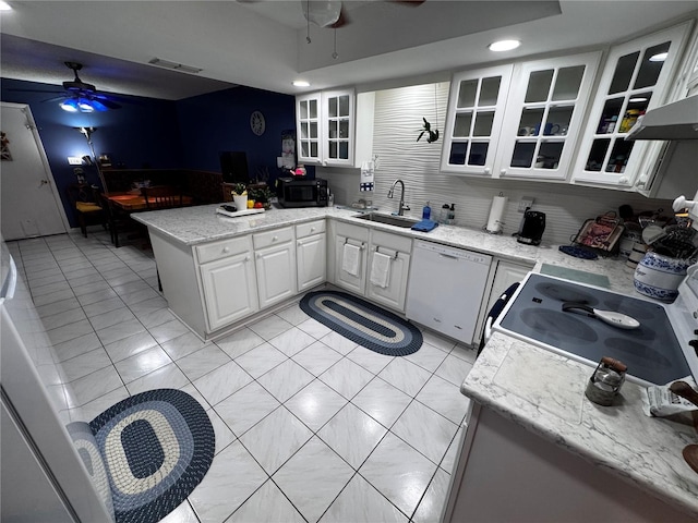 kitchen featuring sink, white dishwasher, kitchen peninsula, ceiling fan, and white cabinets