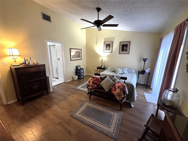 bedroom featuring lofted ceiling, a textured ceiling, and dark hardwood / wood-style flooring