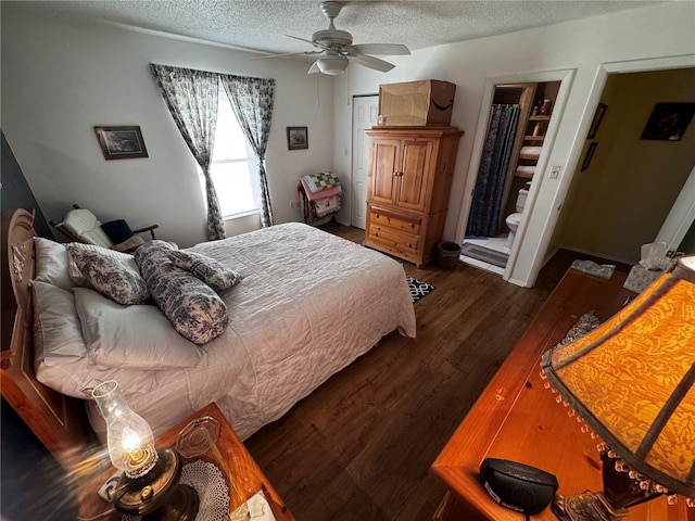 bedroom with dark hardwood / wood-style flooring, ceiling fan, and a textured ceiling