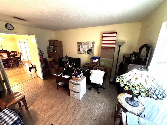 living room featuring hardwood / wood-style floors and a textured ceiling