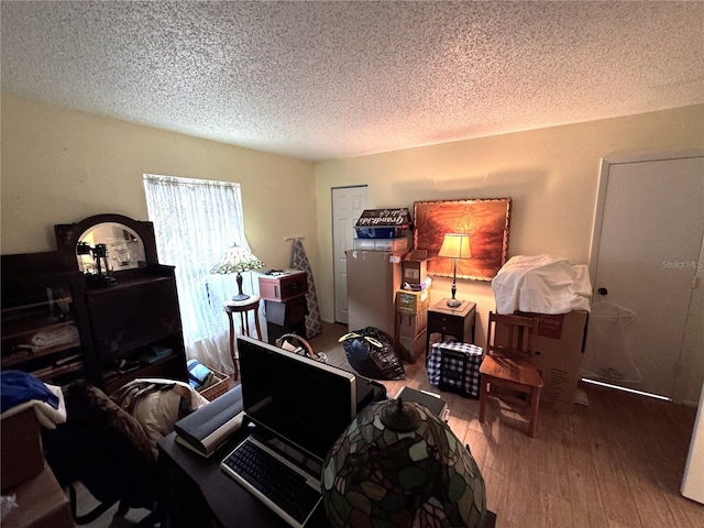 office with hardwood / wood-style floors and a textured ceiling